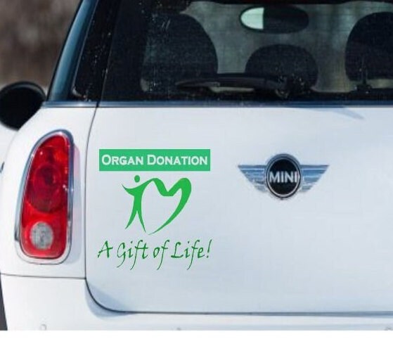 “Organ Donation — A Gift of Life vinyl car window decal, white, 9‑inch width, die‑cut with no background on tinted rear glass”