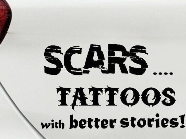 “Black ‘Scars — Tattoos with Better Stories’ car decal on light tailgate, 11‑inch width, high‑contrast lettering”
