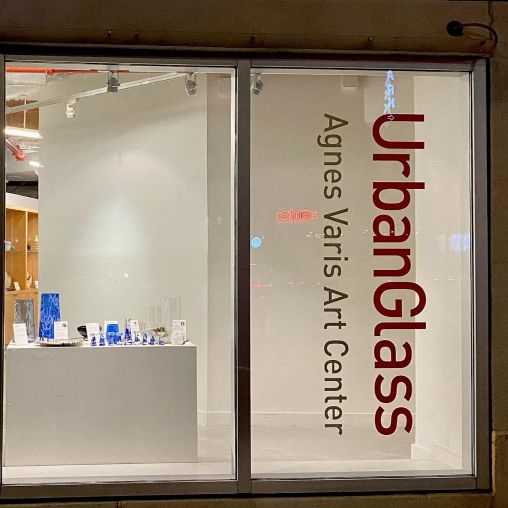Company logo and website die‑cut white vinyl window decal on shopfront glass, clean professional finish