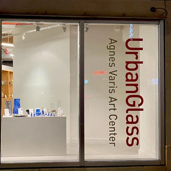 Company logo and website die‑cut white vinyl window decal on shopfront glass, clean professional finish