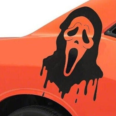 Scream Ghost face vinyl decal on orange car
